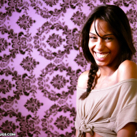 Smiley ebony floosie with pigtail uncovering her tiny titties