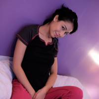 Delectable Lilly Evans massages her moist pussy in bed