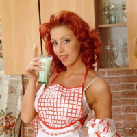 Sexy redhead Ashley Robbins playing with milk in the kitchen