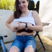Playful Talia Amanda shows her large jugs outside