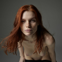 Redhead model Vi Kolodko in black stockings fooling around
