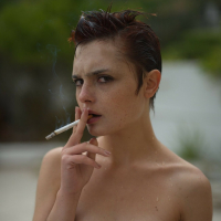 Naughty short haired girl Caterina Foxy revealing her tiny naked tits