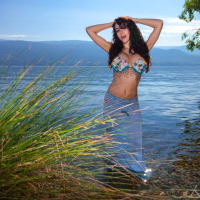 Katie Banks posing naked next to a beautiful Lake