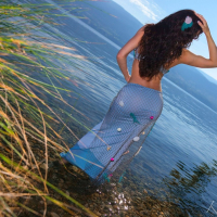 Katie Banks posing naked next to a beautiful Lake
