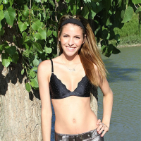 Sexy babe Shiny Lola posing outdoors by a River