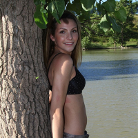 Sexy babe Shiny Lola posing outdoors by a River