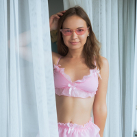 Lovely chick Yenn Cat strips down to unveil her tight shaved pussy
