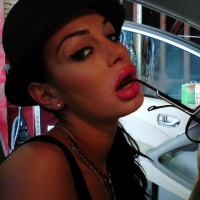 Angelina Valentine teasing with her red lips and pink nails