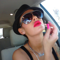 Angelina Valentine teasing with her red lips and pink nails