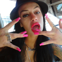 Angelina Valentine teasing with her red lips and pink nails