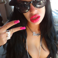 Angelina Valentine teasing with her red lips and pink nails