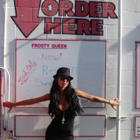 Angelina Valentine teasing with her red lips and pink nails