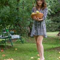 Brunette Julia Morozzi with small tits posing naked in a park