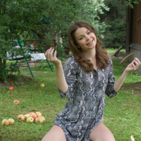Brunette Julia Morozzi with small tits posing naked in a park