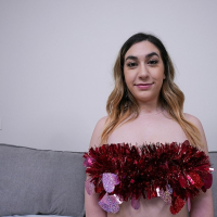 Lexi Grey lays on the bed with rose petals