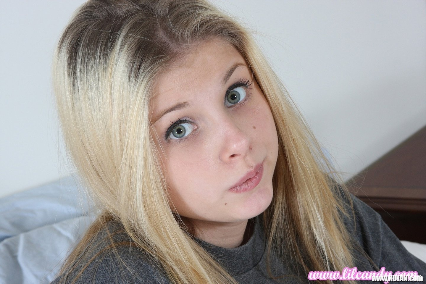 Pretty Lil Candy poses in a grey tshirt before fingering her tight pussy - Photo #3234393
