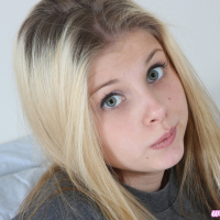 Pretty Lil Candy poses in a grey tshirt before fingering her tight pussy