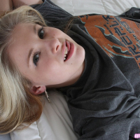 Pretty Lil Candy poses in a grey tshirt before fingering her tight pussy