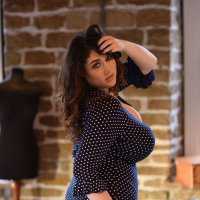 Curvy brunette lady Bella Brewer flashes her massive melons