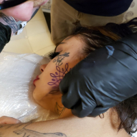 Tattooed babe Genevieve Sinn gives a hot blowjob