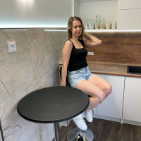 Solo Amelia Jones having fun while doing striptease in the kitchen