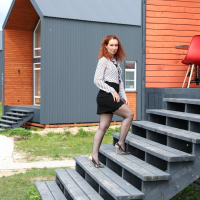 Redhead Kate Shira with natural tits wearing black fishnet stockings