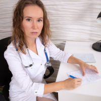 Horny doctor Kate Shira strips naked and rubs her shaved pussy