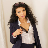 Curly haired chick Mini Mitzi X removes here office clothes for Only Tease