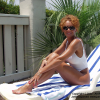 Janet Mason stripping and posing outside