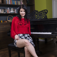 Brunette Viola Weber having fun while posing naked by the piano