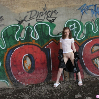 Pretty Lil Candy poses outdoors and spreads her tight little pussy
