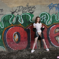Pretty Lil Candy poses outdoors and spreads her tight little pussy