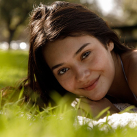 Young babe in bikini enjoys sunny day in the park