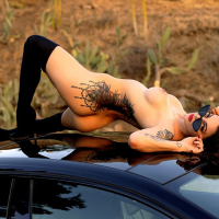 Tattooed Maddy May with hot ass and natural tits posing on a car