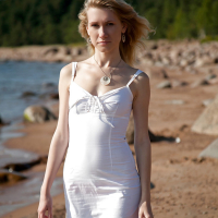 Lovely young girl Mariana strips and shows her shaved pussy on the beach