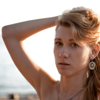 Lovely young girl Mariana strips and shows her shaved pussy on the beach