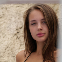 Adorable Olya Derkach sunbathing and posing by the pool in a black bikini