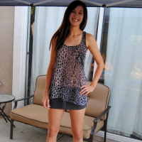 Pretty brunette babe posing in a see through leopard print shirt