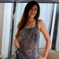 Pretty brunette babe posing in a see through leopard print shirt