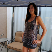 Pretty brunette babe posing in a see through leopard print shirt