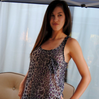 Pretty brunette babe posing in a see through leopard print shirt