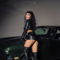 Long legs brunette Scarlett Kapella posing on the car