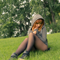 Redhead Jeny Smith posing outdoors in Nylons