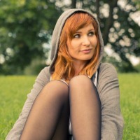 Redhead Jeny Smith posing outdoors in Nylons