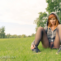 Redhead Jeny Smith posing outdoors in Nylons