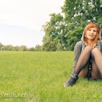 Redhead Jeny Smith posing outdoors in Nylons