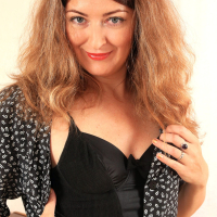 Helen Volga posing in black Lingerie and using Toy