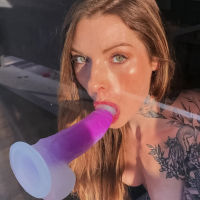 Penny Archer stuffs her pussy with a purple dildo