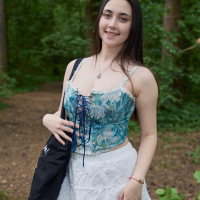 Busty brunette girl Remido revealing her naked melons in the park
