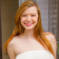 Busty redhead Amanda Love reveals her giant Boobs